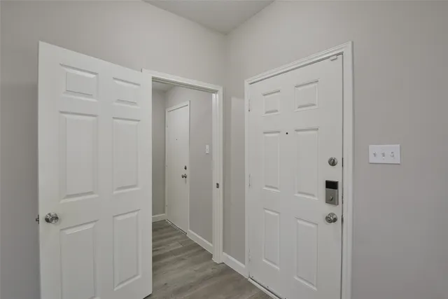 a view of a hallway with wooden floor