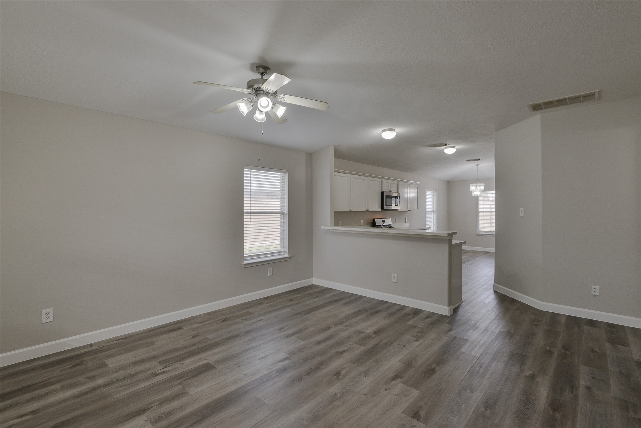 13027 Lark Point Court Houston, TX 77044 - Photo 5 of 29 a view of an empty room with kitchen and window