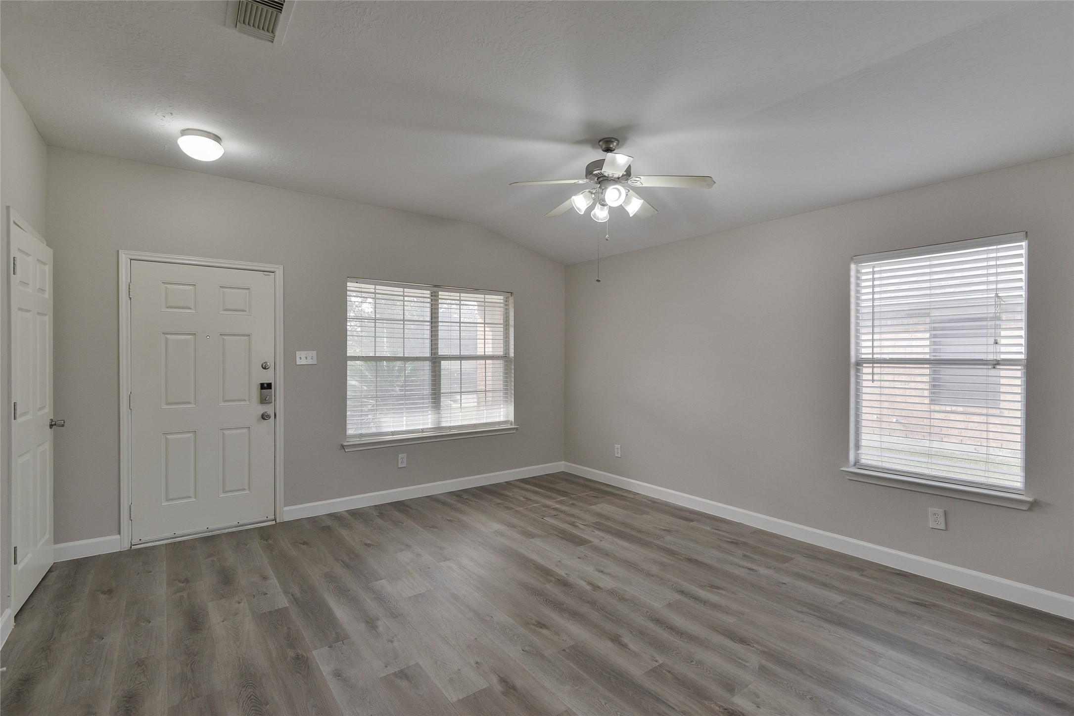 13027 Lark Point Court Houston, TX 77044 - Photo 8 of 29 a view of empty room with wooden floor and fan