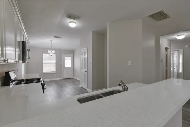 a kitchen with a sink stove and microwave