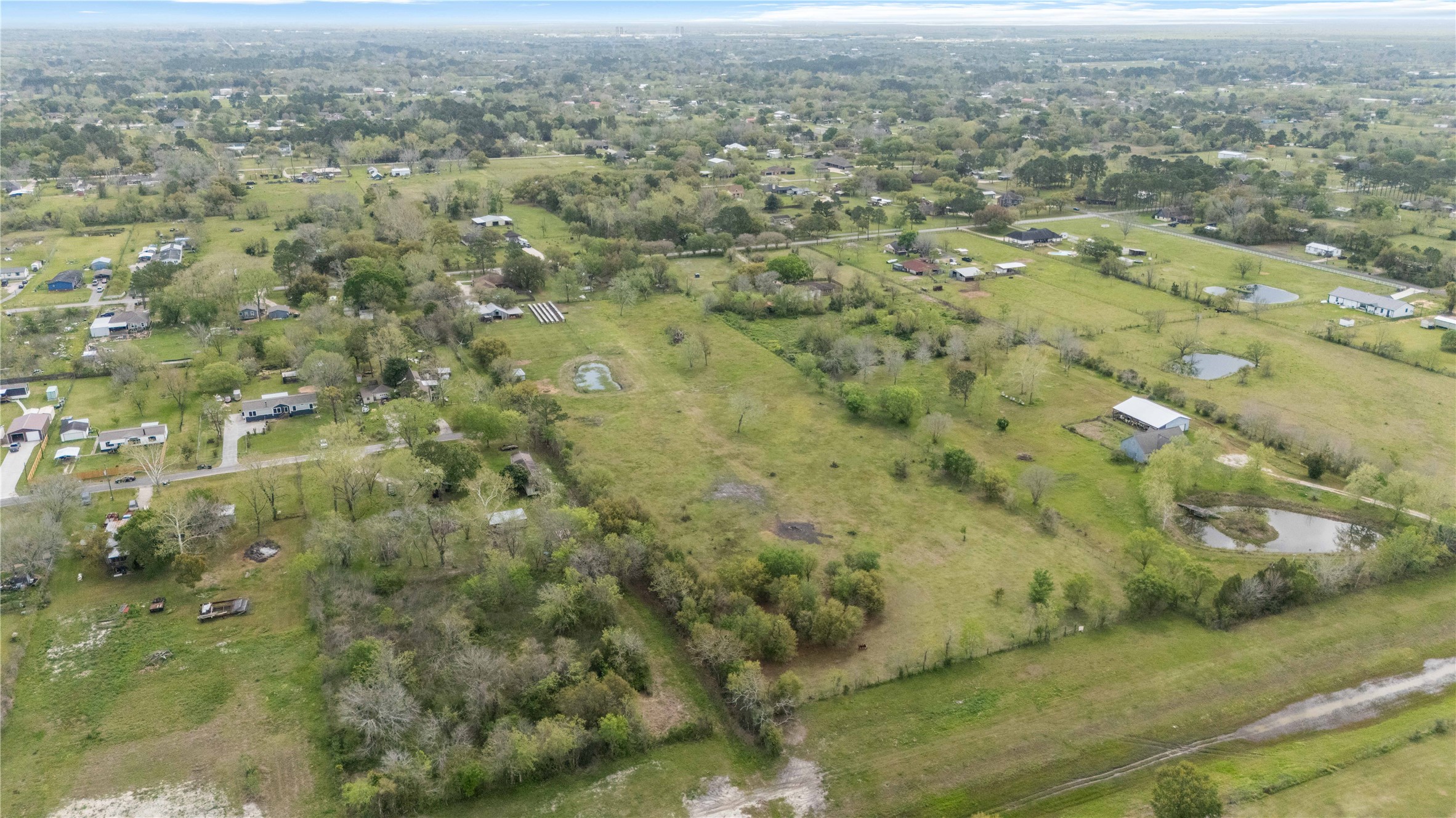0 Burdock Drive Santa Fe, TX 77510 - Photo 1 of 10 a view of a city with lush green forest