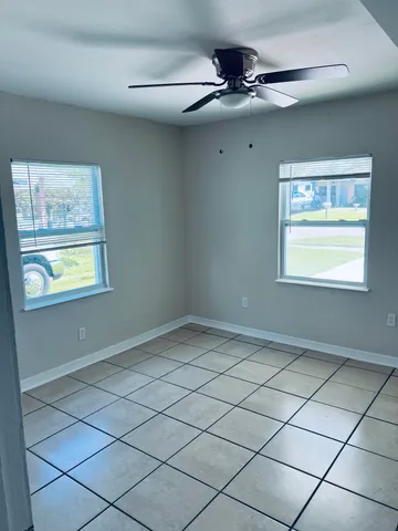 a view of a livingroom with an empty space and a window