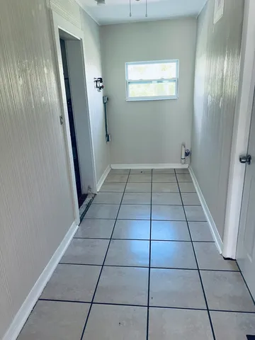 a view of a livingroom with a ceiling fan and window