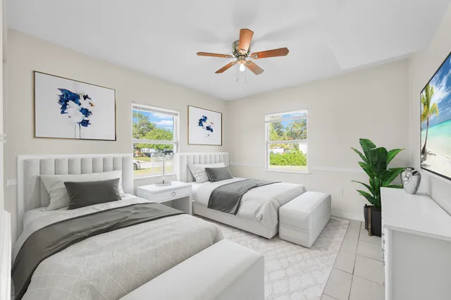 a view of an house with backyard and a tree