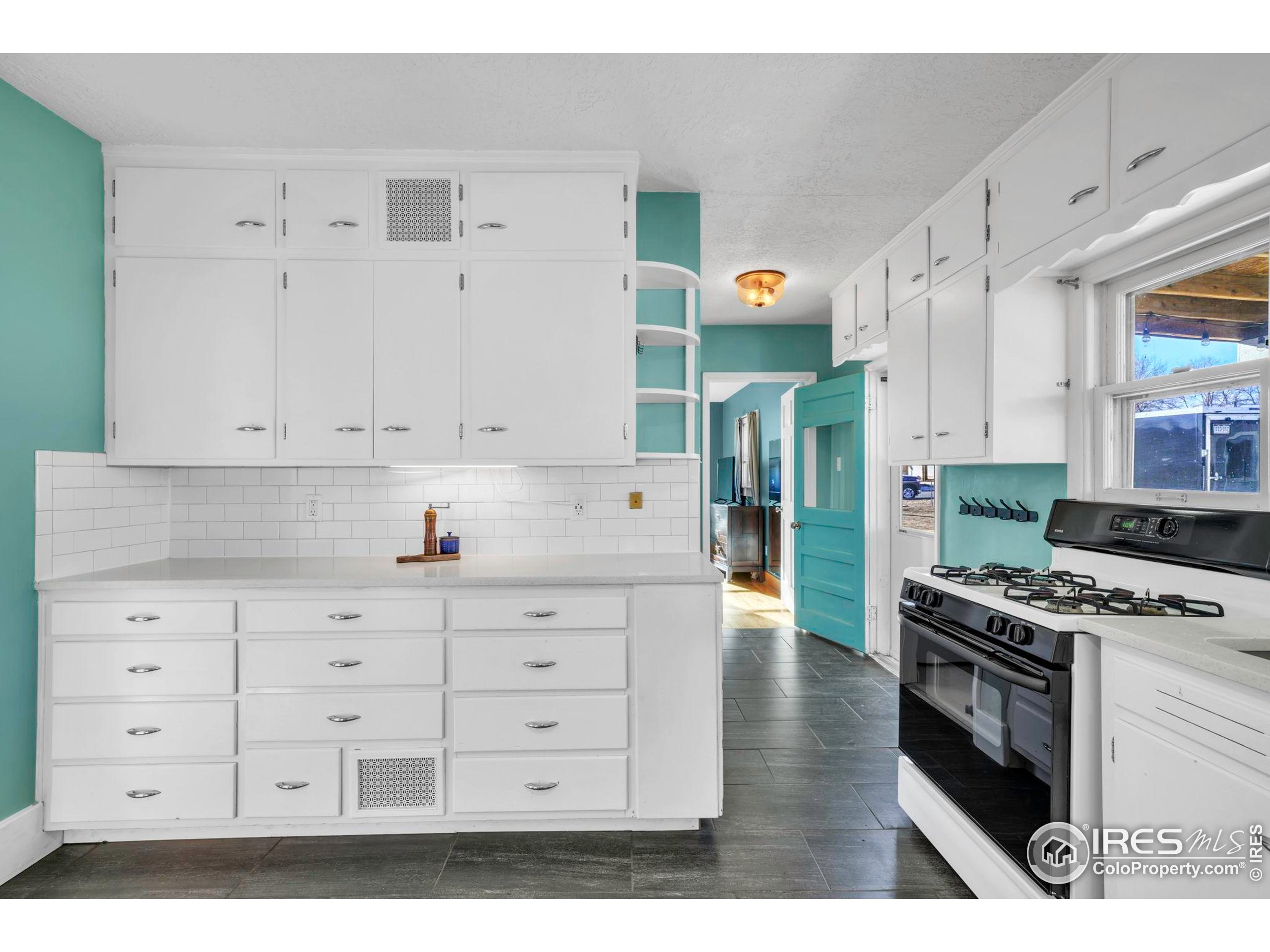 409 Main Street Mead, CO 80542 - Photo 13 of 35 a kitchen with cabinets appliances and a wooden floor