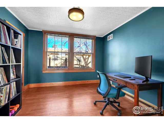 a workspace with furniture bookshelf and a window