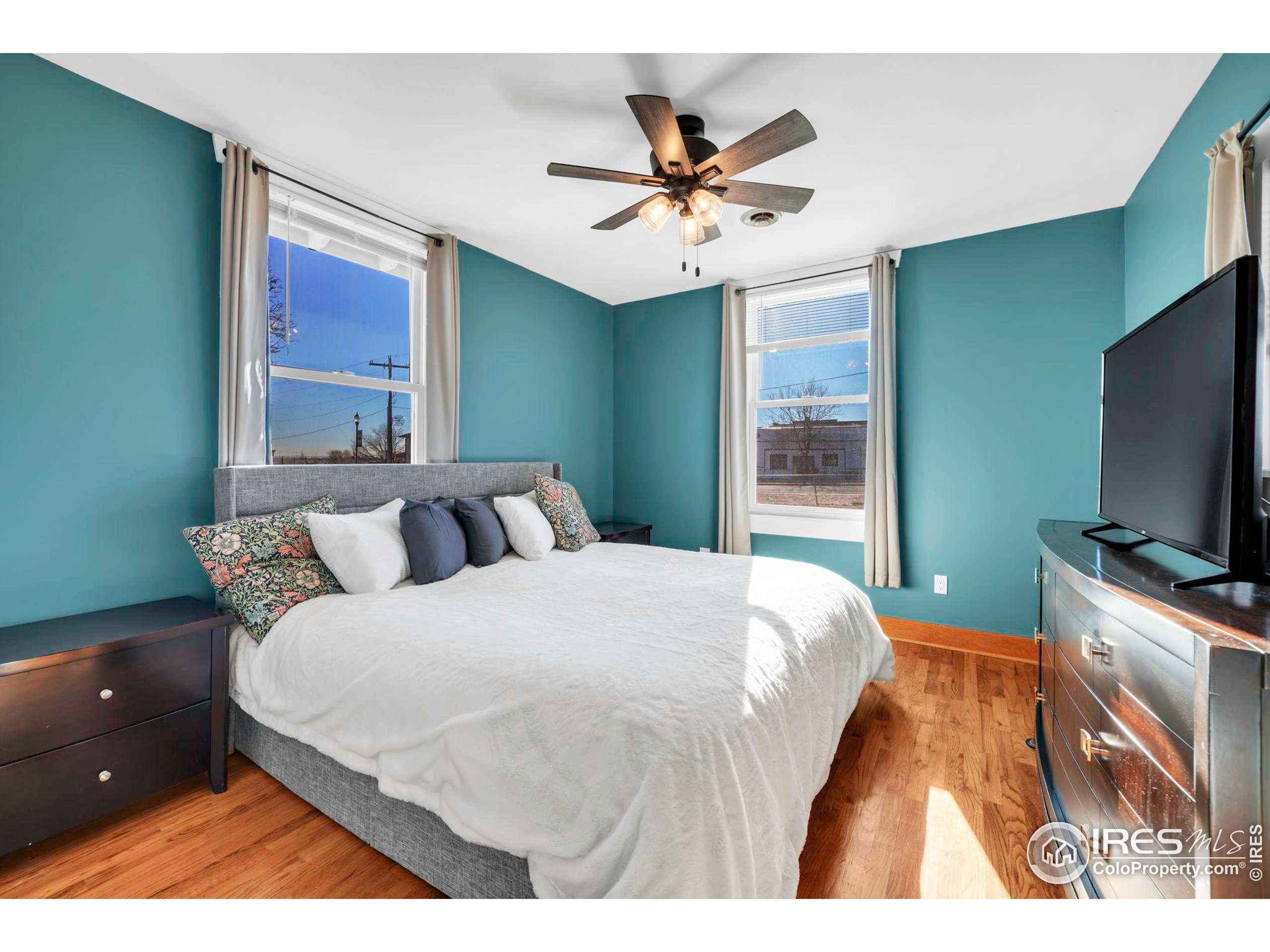 409 Main Street Mead, CO 80542 - Photo 16 of 35 a bedroom with a bed and a flat screen tv