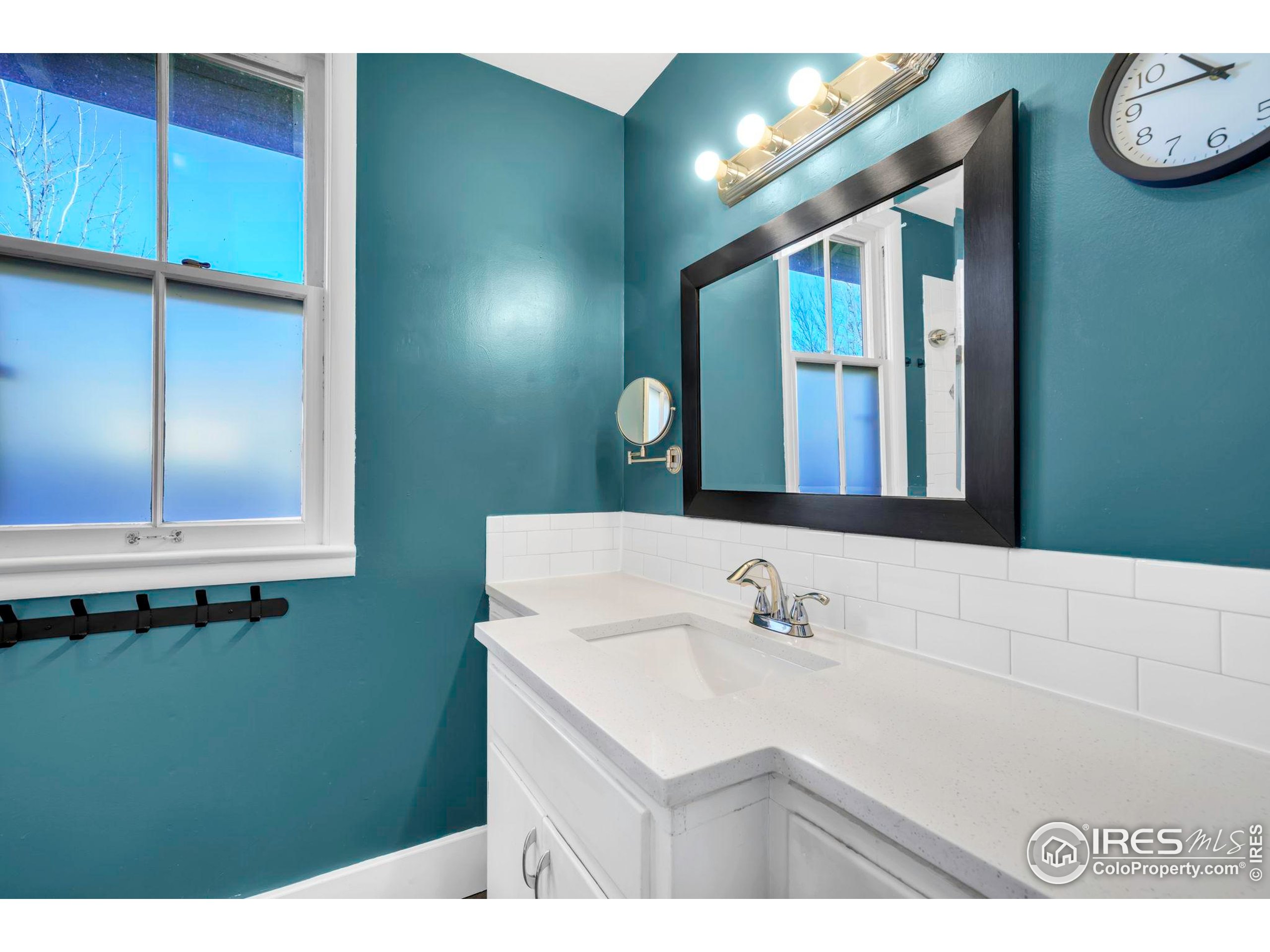 409 Main Street Mead, CO 80542 - Photo 19 of 35 a bathroom with a sink and a mirror