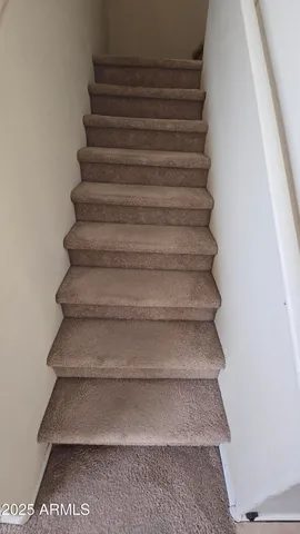 an empty room with chandelier fan