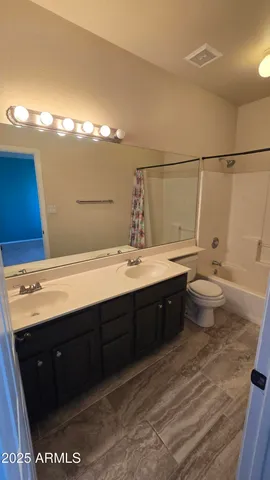 an empty room with a bathroom and a sink