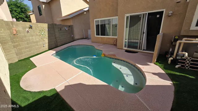 an aerial view of a house with swimming pool and porch