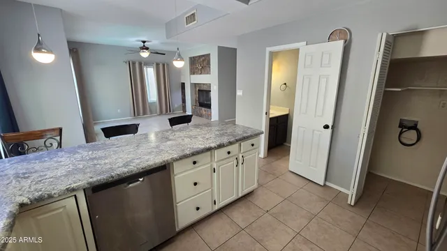 a bathroom with a granite countertop sink a mirror and a shower