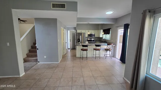 a view of kitchen with sink and refrigerator