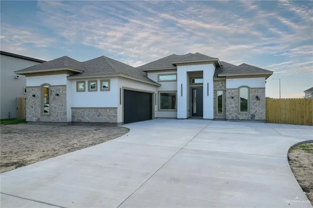 a view of a house with a yard and garage