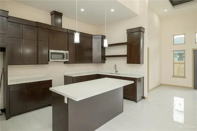 a kitchen with stainless steel appliances a sink stove and refrigerator