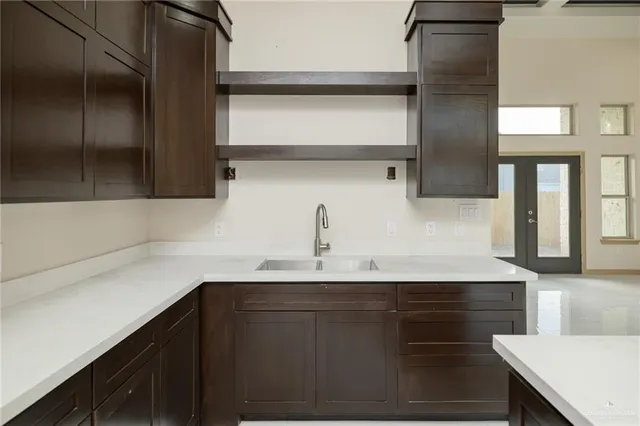 a kitchen with a sink and cabinets