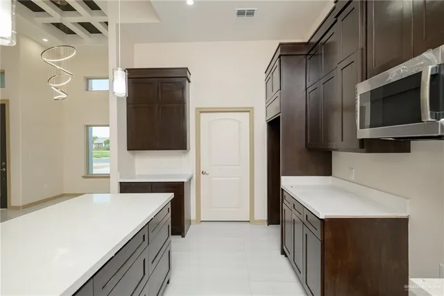 a kitchen with stainless steel appliances a refrigerator and a stove