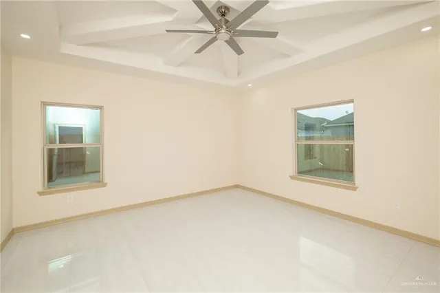 an empty room with a window and a ceiling fan