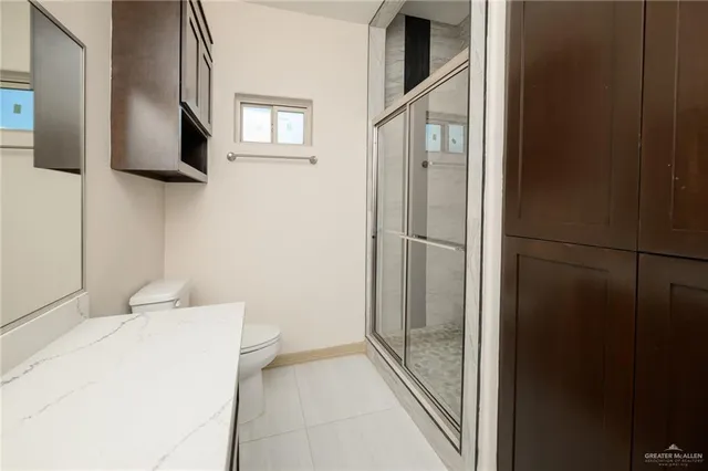 a bathroom with a shower and a sink