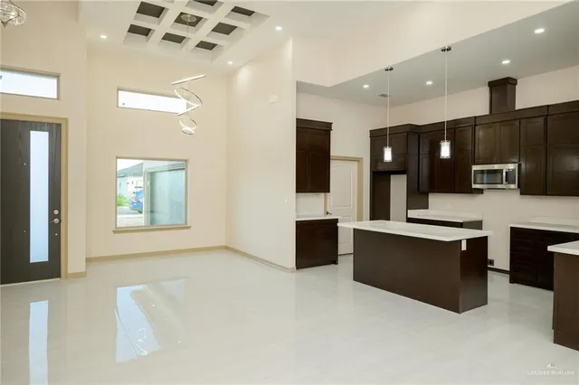 a large kitchen with stainless steel appliances a large counter top