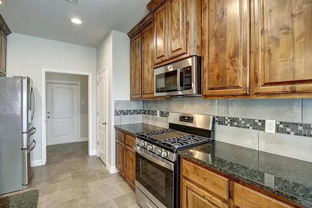 a kitchen that has a sink and a stove