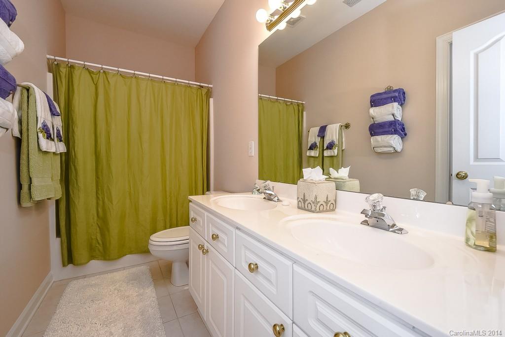 3513 Rhett Butler Place Charlotte, NC 28270 - Photo 18 of 24 a bathroom with a sink a toilet and shower curtain