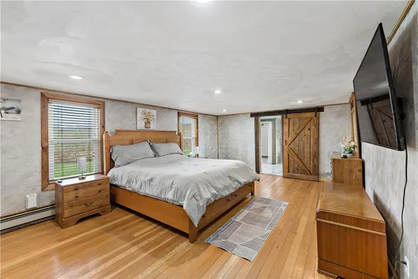 a spacious bedroom with a bed and large windows