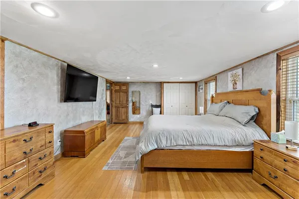 a bedroom with a bed and flat screen tv