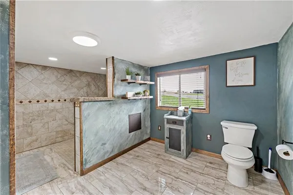 a large bathroom with a granite countertop sink a mirror and a shower
