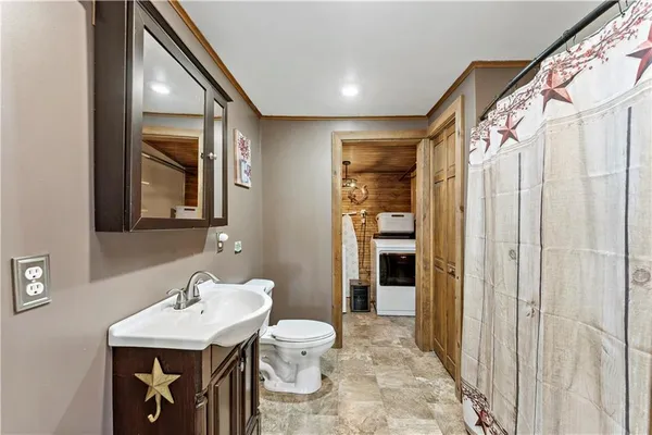 a bathroom with a toilet a sink and mirror
