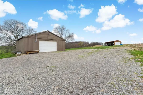 a view of a house with a yard and garage