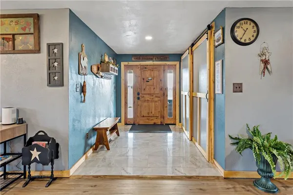 a view of a hallway with entryway wooden floor and front door