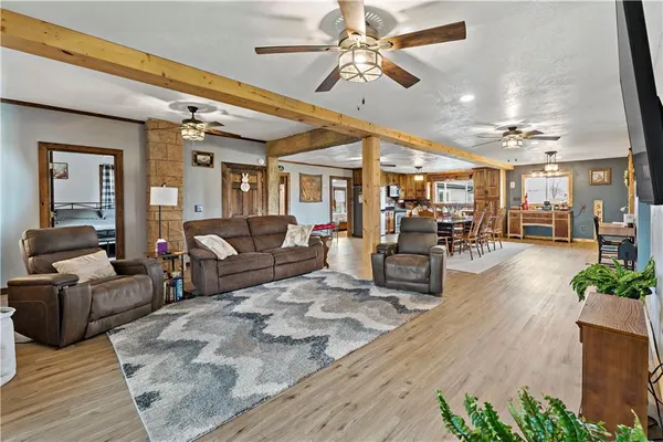 a living room with furniture and a chandelier