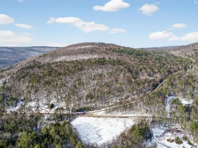 a view of mountain view with trees in the background