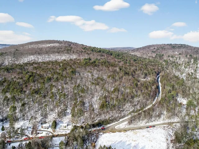 a view of a mountain range with trees in the background