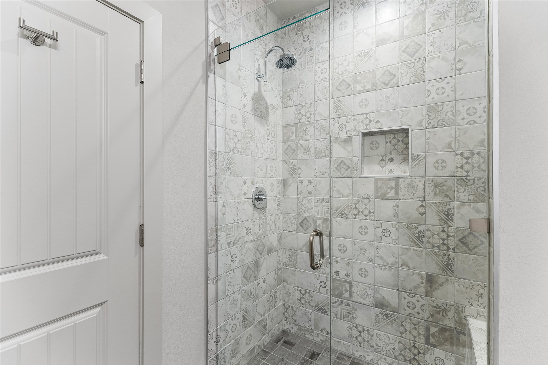 8110 Ranch Road 2222, Unit 68 Austin, TX 78730 - Photo 12 of 24 A striking patterned tile shower with a frameless glass enclosure.