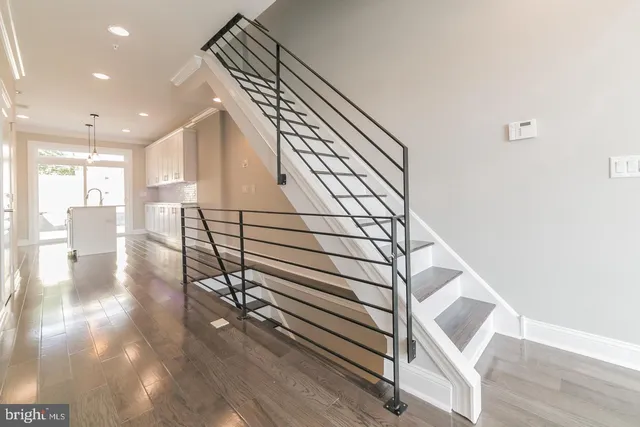 a view of entryway and hall with wooden floor
