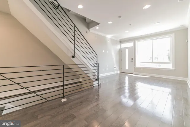 a view of entryway and hall with wooden floor