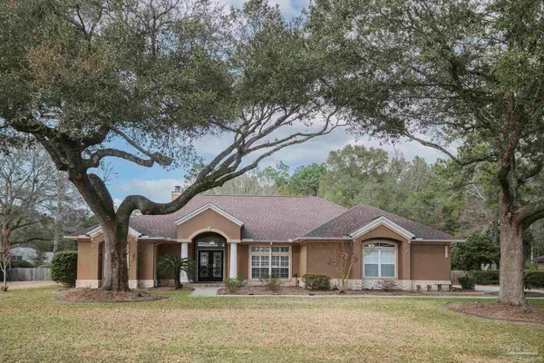 a front view of a house with a yard covered in snow