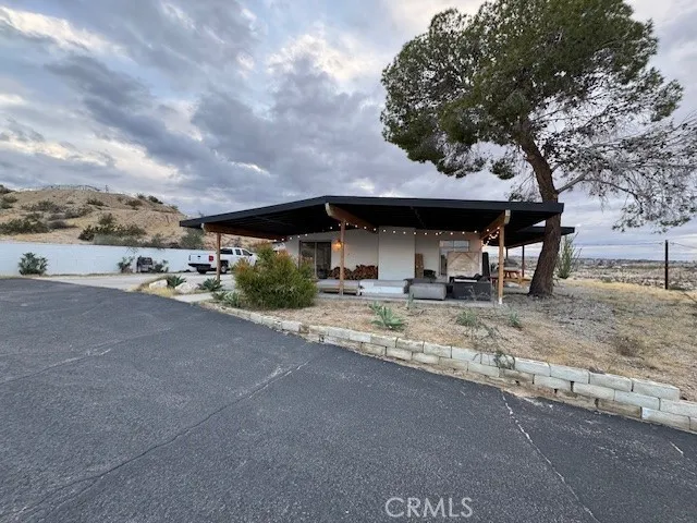 a backyard of a house with table and chairs