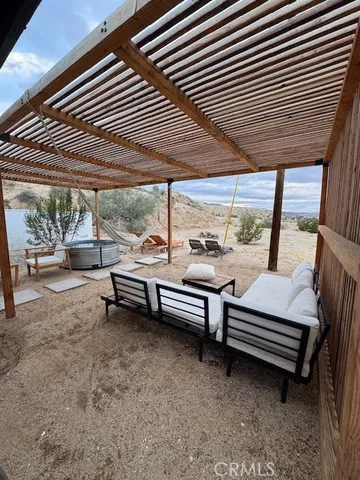 a backyard of a house with barbeque oven table and chairs