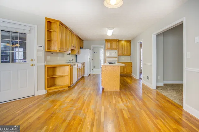 a view of a living room with furniture and wooden floor