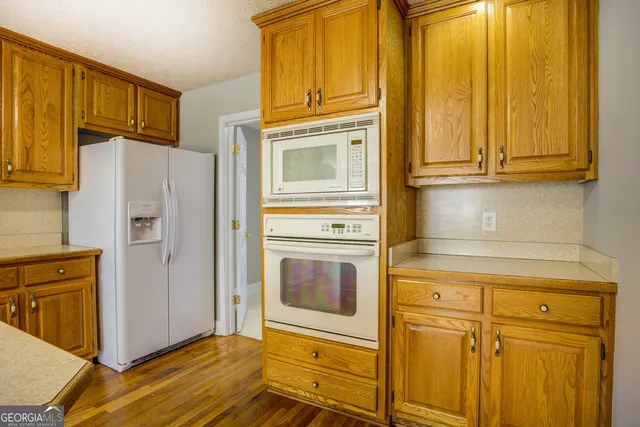 a kitchen with granite countertop cabinets stainless steel appliances and counter space