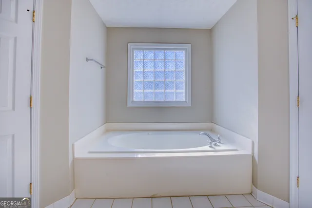a white bath tub sitting in a bathroom