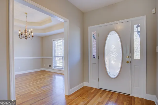 a view of a room with wooden floor and mirror