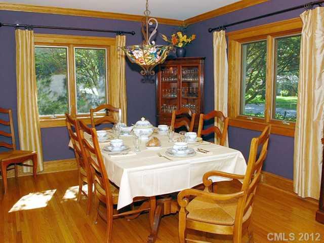 1521 Andover Road Charlotte, NC 28211 - Photo 3 of 16 a view of a dining room with furniture a chandelier and wooden floor
