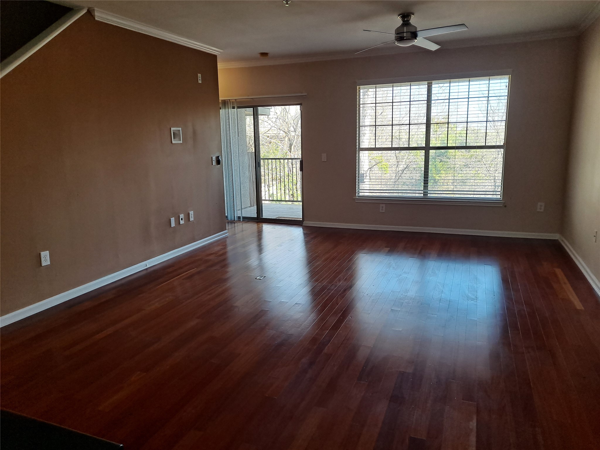 11203 Ranch Road 2222, Unit 2404 Austin, TX 78732 - Photo 3 of 28 Spacious room featuring wood-finish flooring, a contemporary ceiling fan, and crown molding