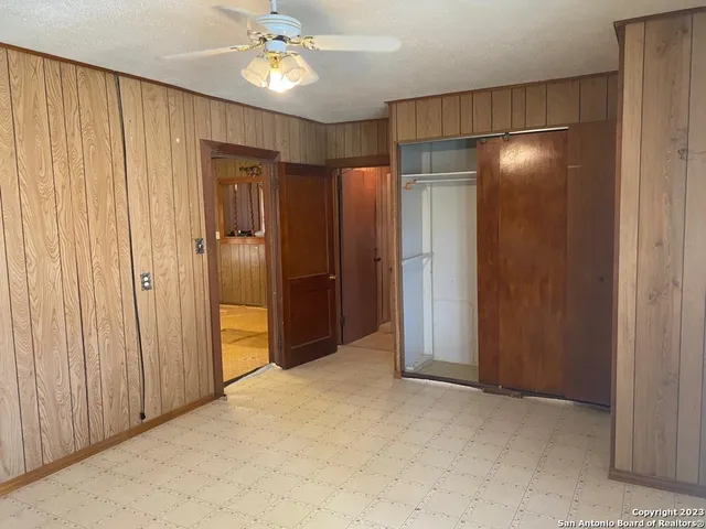 an empty room with closet and entryway