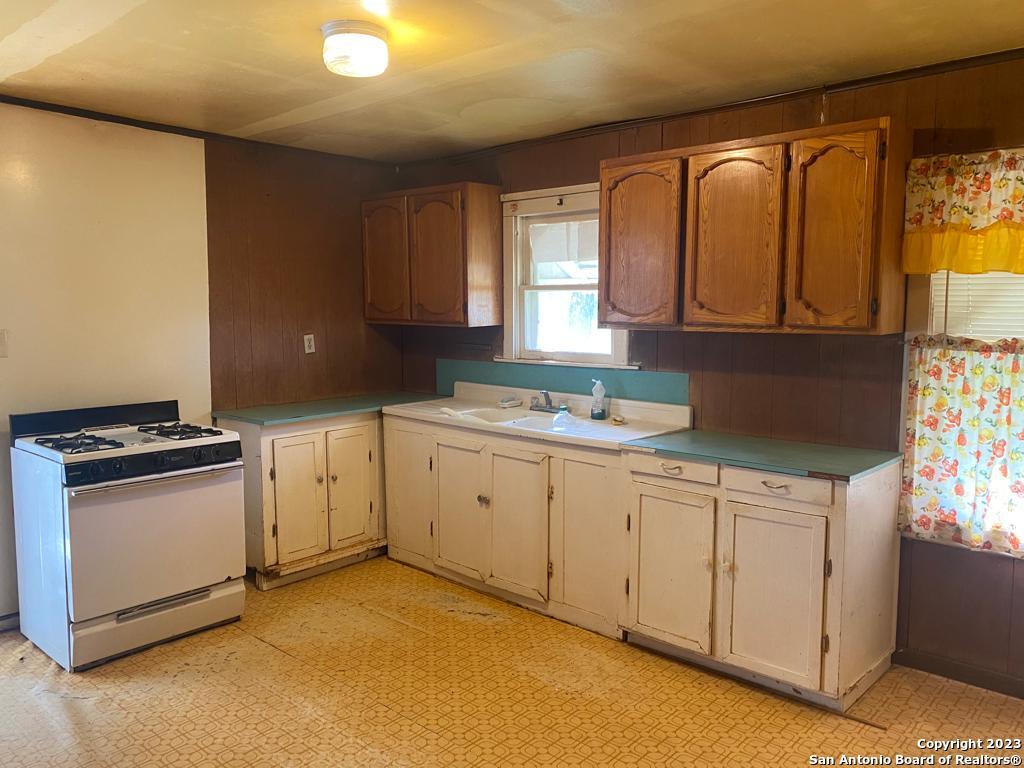 17770 Interstate 35 Lytle, TX 78052 - Photo 20 of 32 a kitchen with granite countertop a sink stove and cabinets