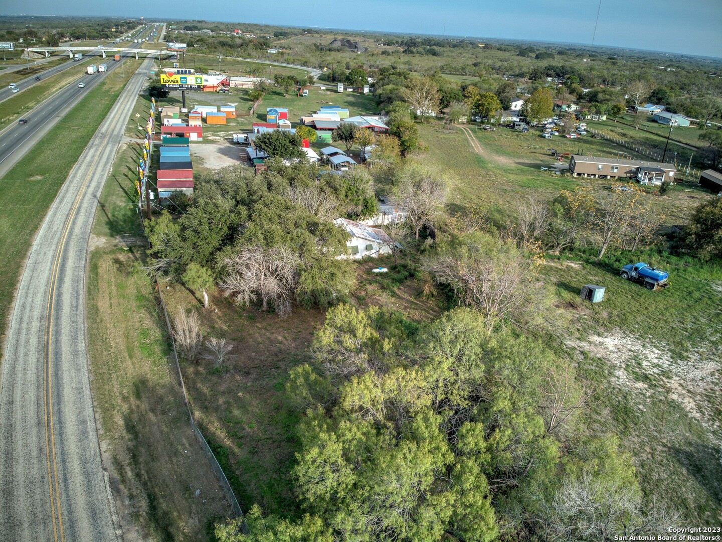17770 Interstate 35 Lytle, TX 78052 - Photo 26 of 32 an aerial view of residential houses with outdoor space and trees